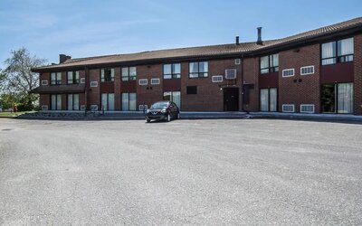 Exterior view of Comfort Inn Sherbrooke with ample guest parking and easy hotel access.