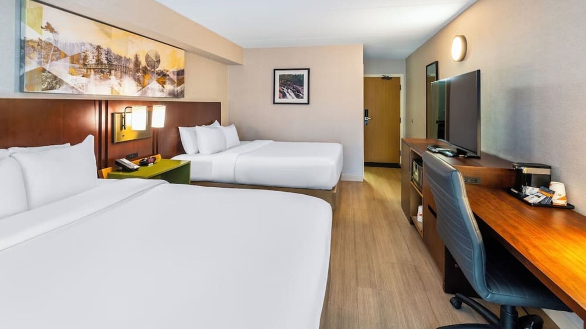 Guest room with two queen beds, workspace, and contemporary amenities at Comfort Inn Sudbury East.