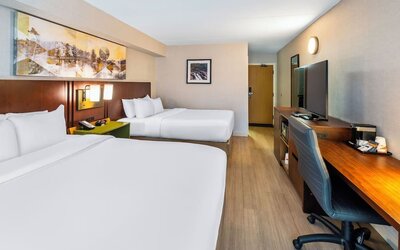Guest room with two queen beds, workspace, and contemporary amenities at Comfort Inn Sudbury East.
