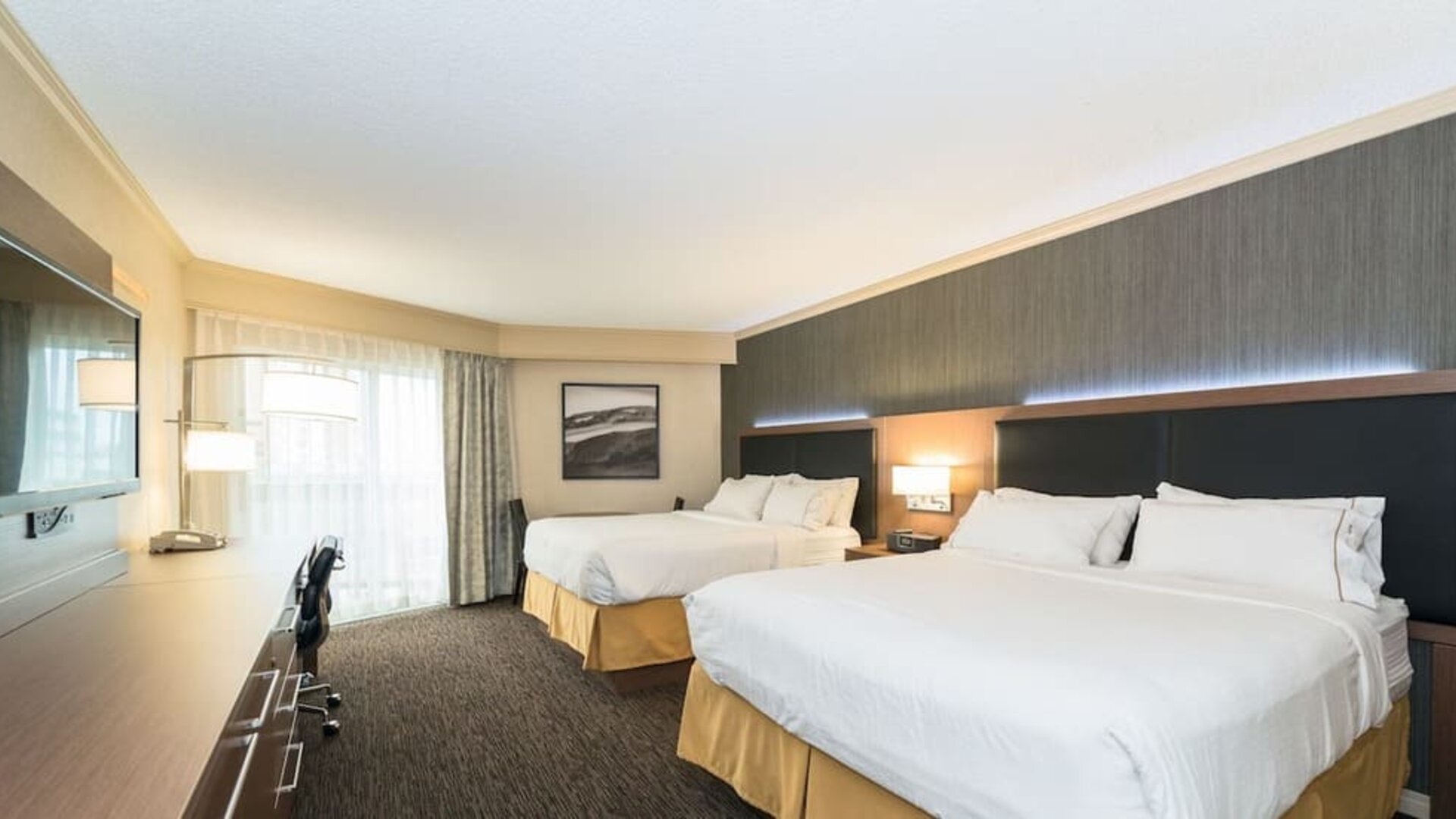 Guest room with two queen beds, workspace, and contemporary furnishings at Holiday Inn Express Edmonton Downtown, an IHG Hotel.