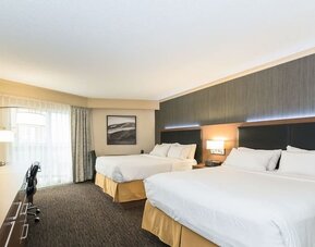 Guest room with two queen beds, workspace, and contemporary furnishings at Holiday Inn Express Edmonton Downtown, an IHG Hotel.