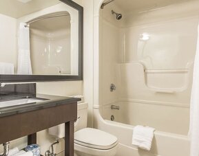 Guest bathroom with a bathtub and shower combination at Comfort Inn Sept-Iles.