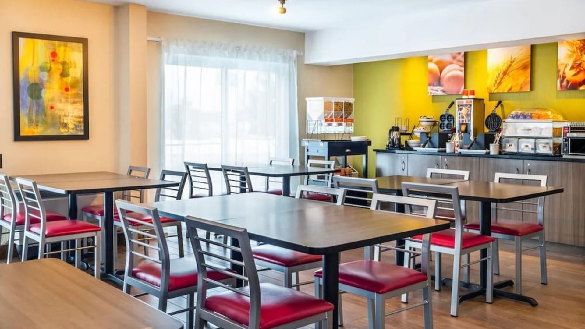 Breakfast dining area with self-serve buffet at Comfort Inn Sept-Iles.