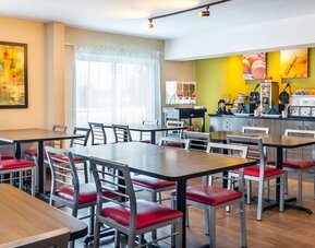 Breakfast dining area with self-serve buffet at Comfort Inn Sept-Iles.