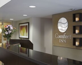 Reception desk with Comfort Inn signage at Comfort Inn Sept-Iles.
