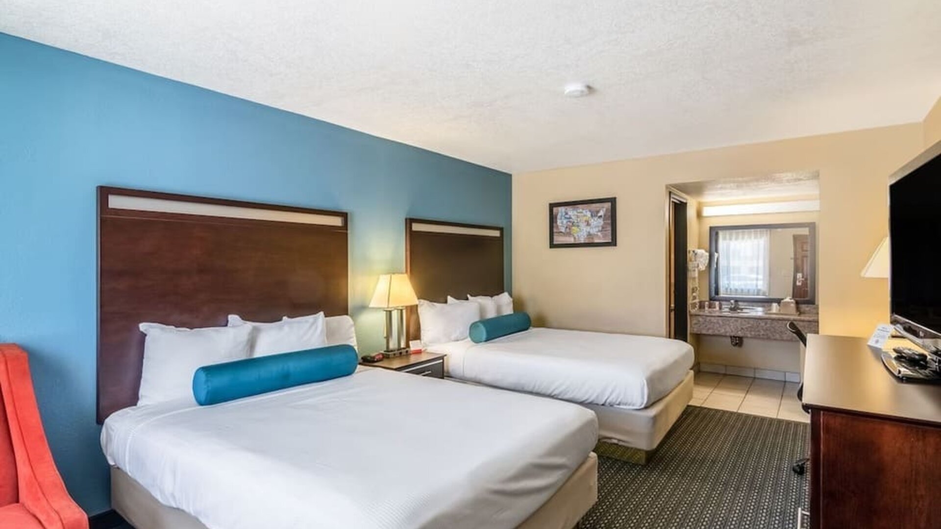 Guest room with two queen beds and a vanity area at Glenridge Inn Glendale Pasadena.