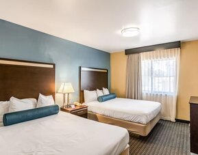 Guest room with two queen beds and a TV at Glenridge Inn Glendale Pasadena.