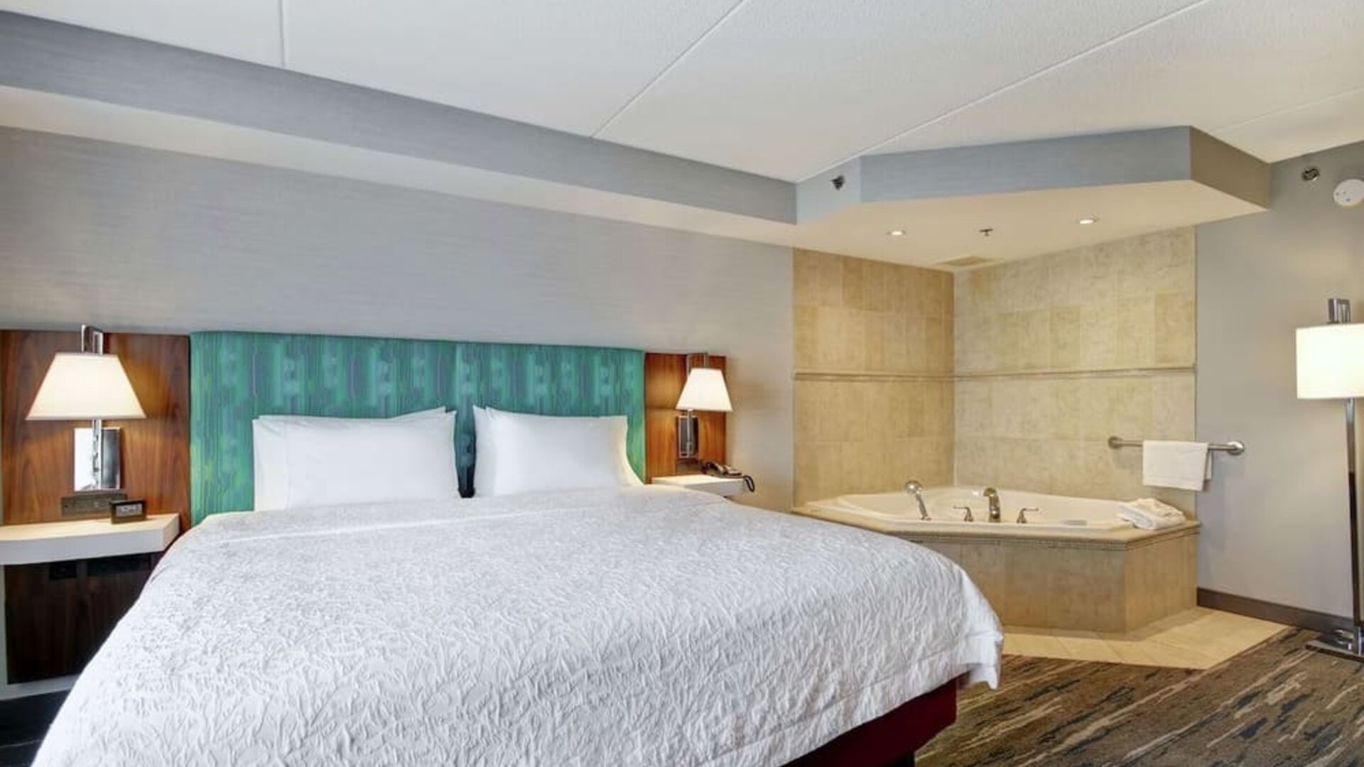 Guest room with a king bed and in-room whirlpool tub at Hampton Inn & Suites By Hilton Guelph.