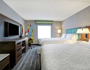 Guest room with two queen beds and modern furnishings at Hampton Inn & Suites By Hilton Guelph.