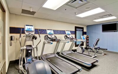 Fitness center with cardio equipment and free weights at Hampton Inn & Suites By Hilton Guelph.