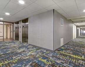 Hotel hallway with elevator access at Hampton Inn & Suites By Hilton Guelph.