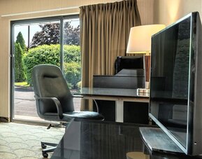 Guest room workspace with a desk and window at Comfort Inn Regina.