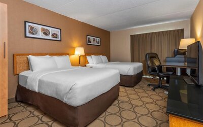 Guest room with two queen beds and a work desk at Comfort Inn Brandon.