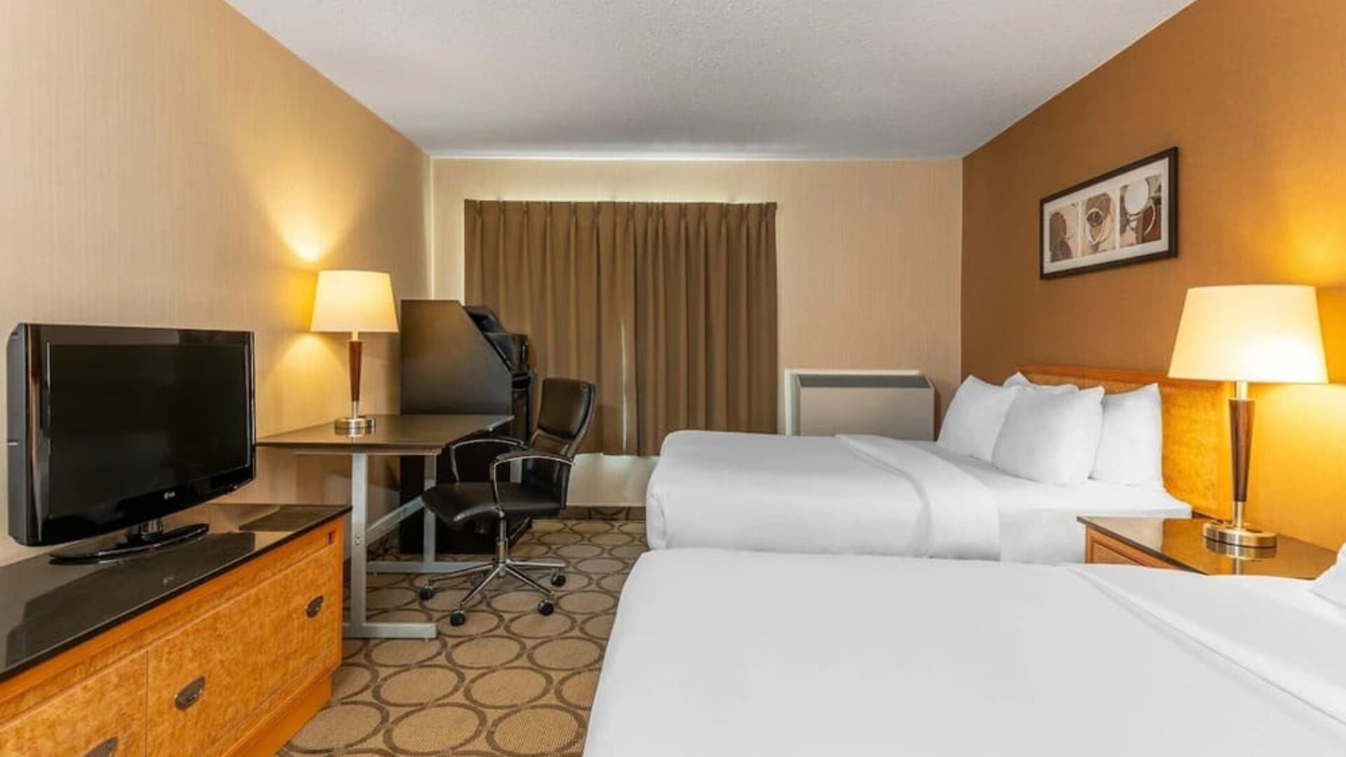 Guest room with two queen beds and a work desk at Comfort Inn Brandon.