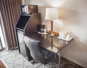 In-room workspace with a desk, coffee station, and mini fridge at Comfort Inn Brandon.