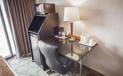 In-room workspace with a desk, coffee station, and mini fridge at Comfort Inn Brandon.