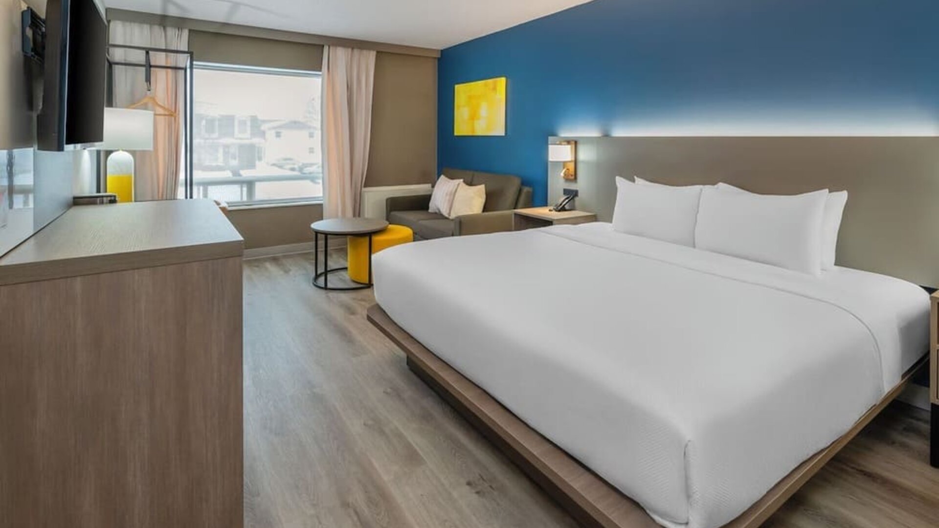 Guest room with a king bed, work desk, and seating area at Comfort Inn Belleville.