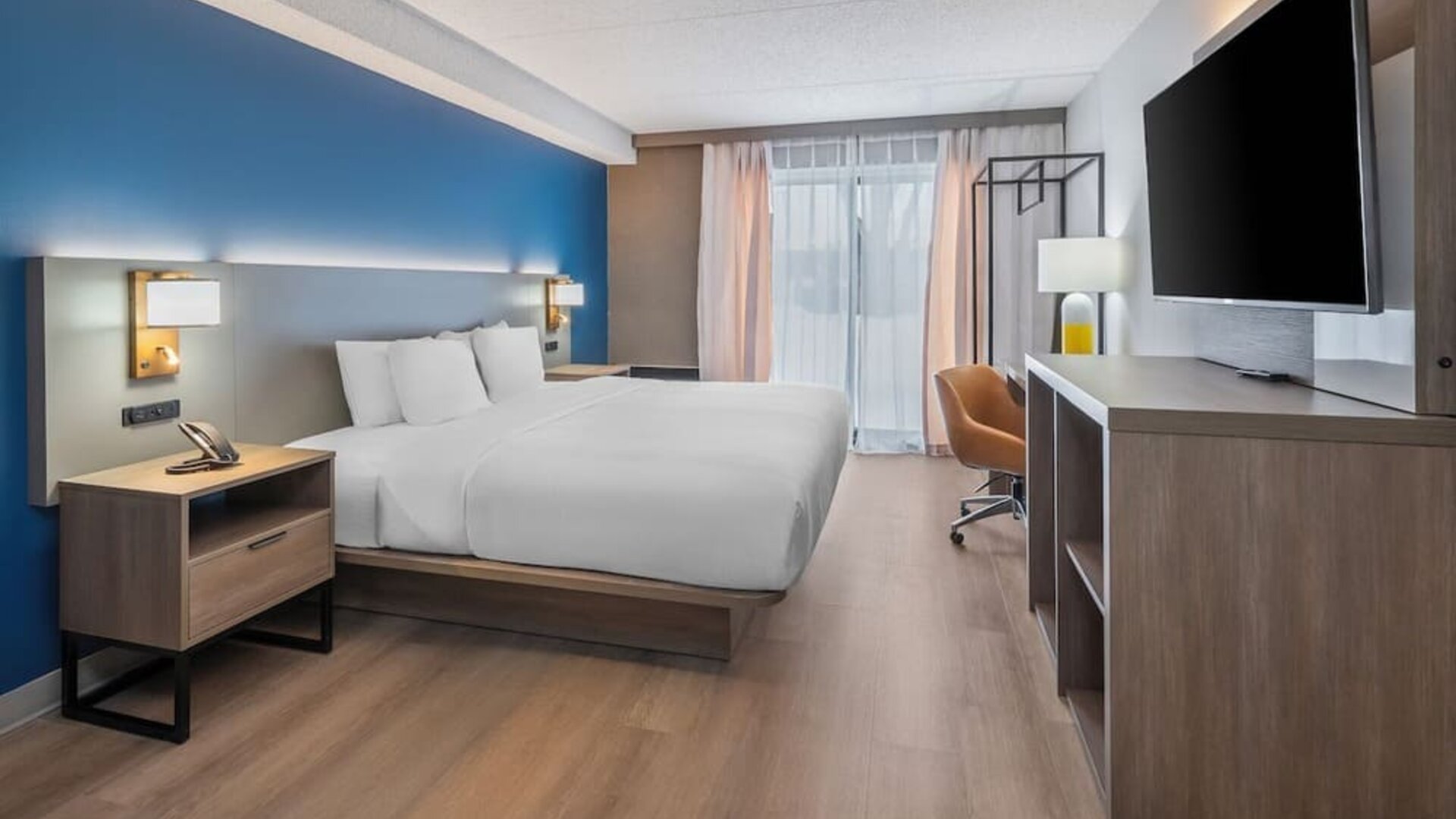 Spacious guest room with a king bed and work desk at Comfort Inn Belleville.