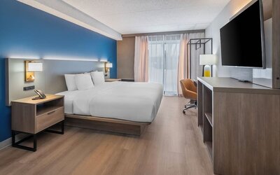 Spacious guest room with a king bed and work desk at Comfort Inn Belleville.