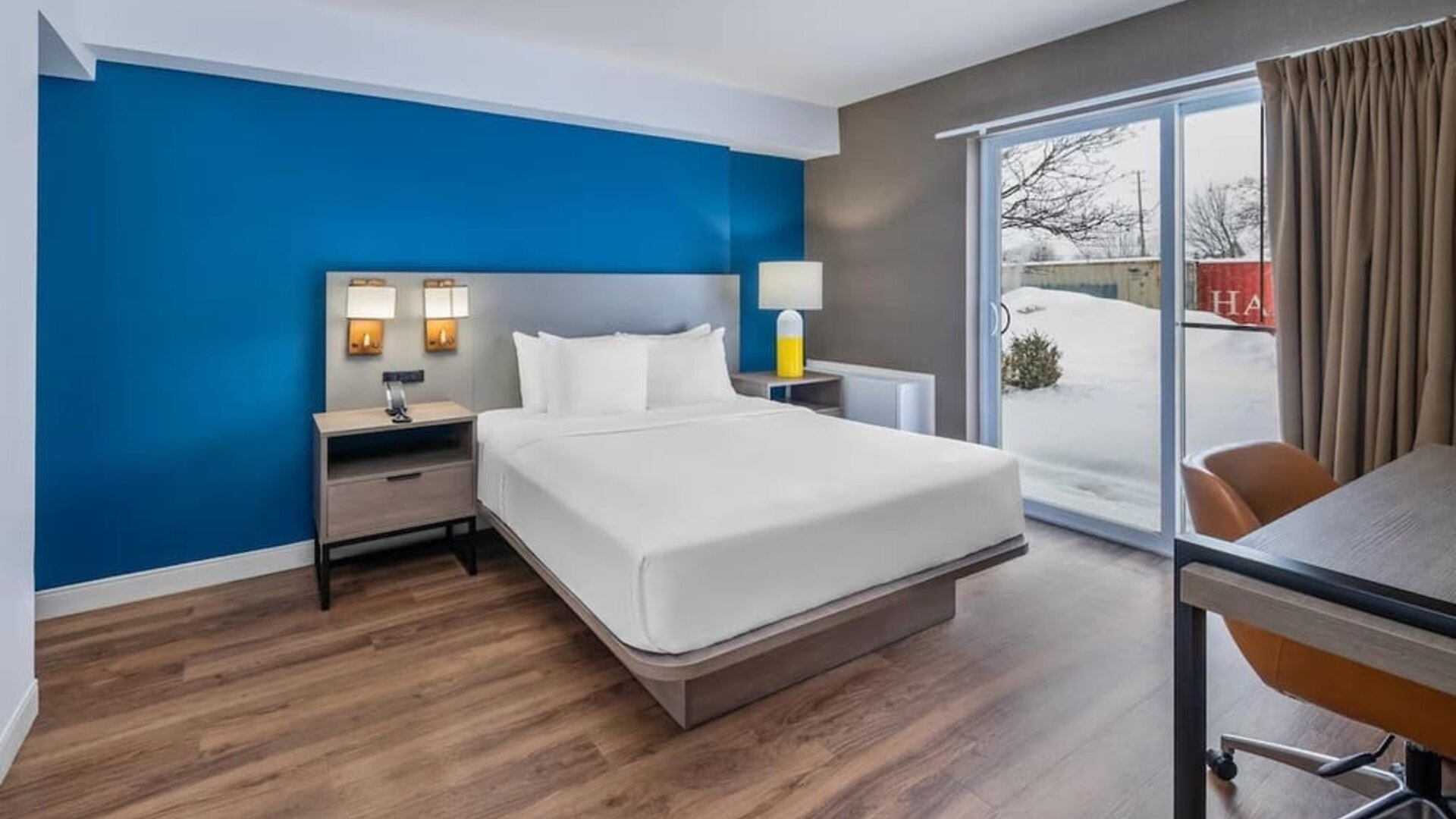 Guest room with a king bed and patio access at Comfort Inn Belleville.
