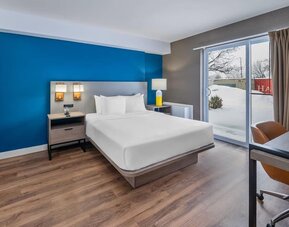 Guest room with a king bed and patio access at Comfort Inn Belleville.