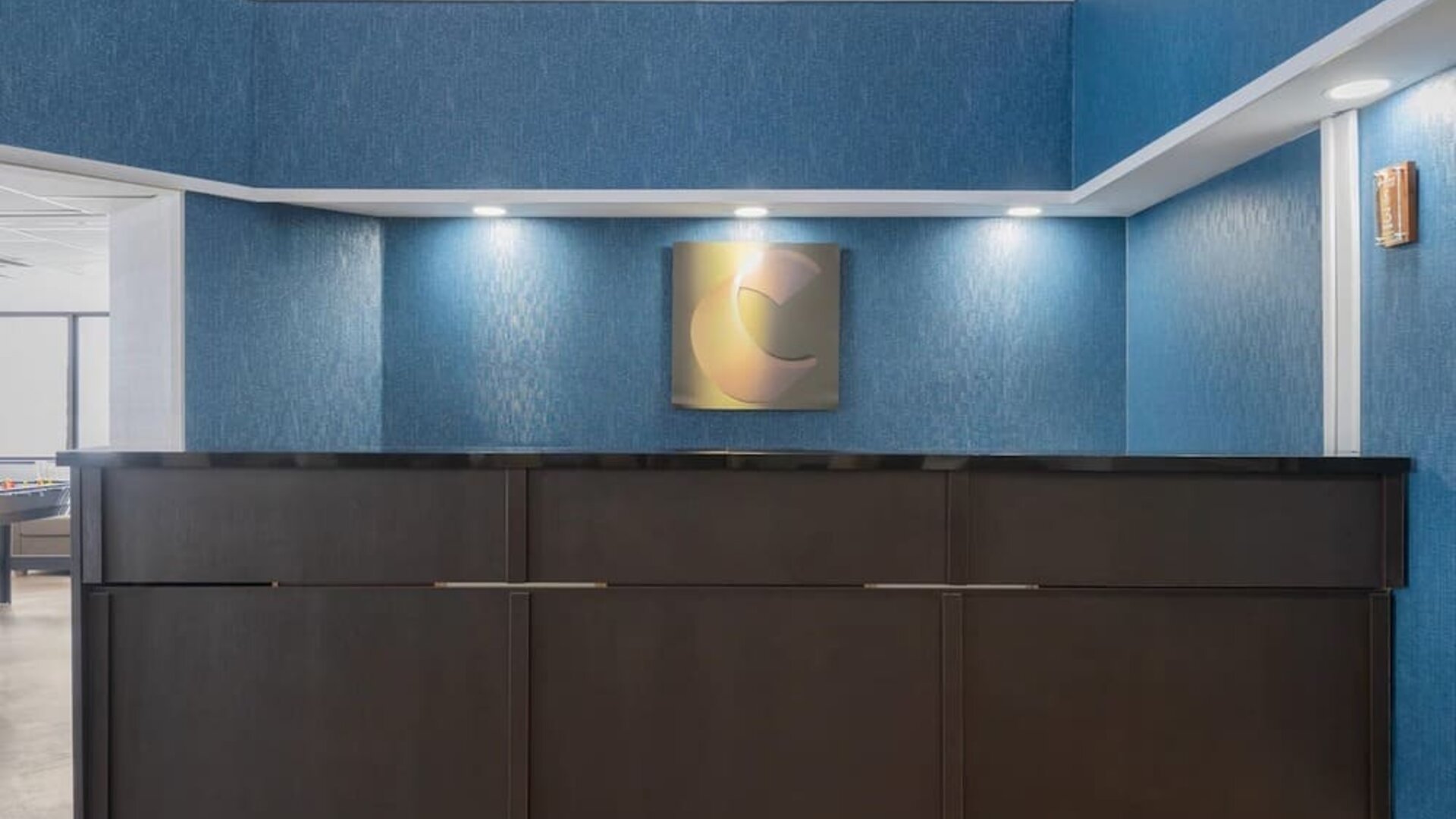 Hotel reception desk with modern design at Comfort Inn Belleville.