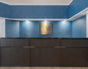 Hotel reception desk with modern design at Comfort Inn Belleville.