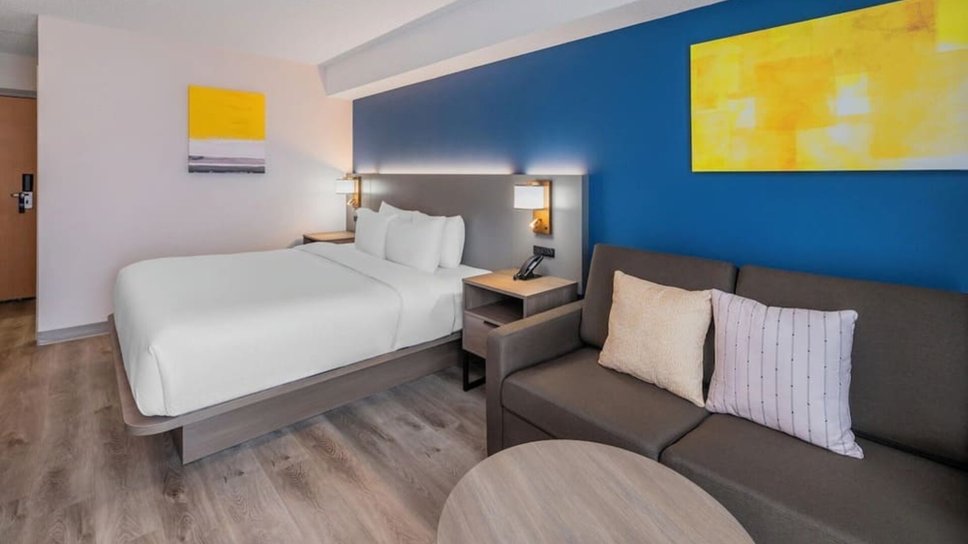 Guest room with a king bed, sofa, and seating area at Comfort Inn Belleville.