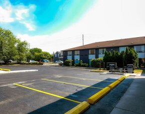 Hotel parking area with outdoor barbecue grills at Comfort Inn Belleville.