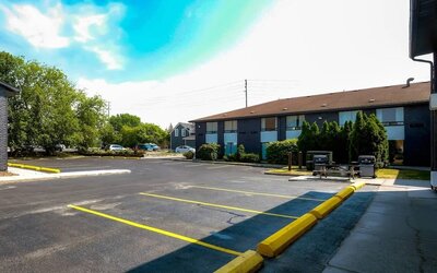 Hotel parking area with outdoor barbecue grills at Comfort Inn Belleville.