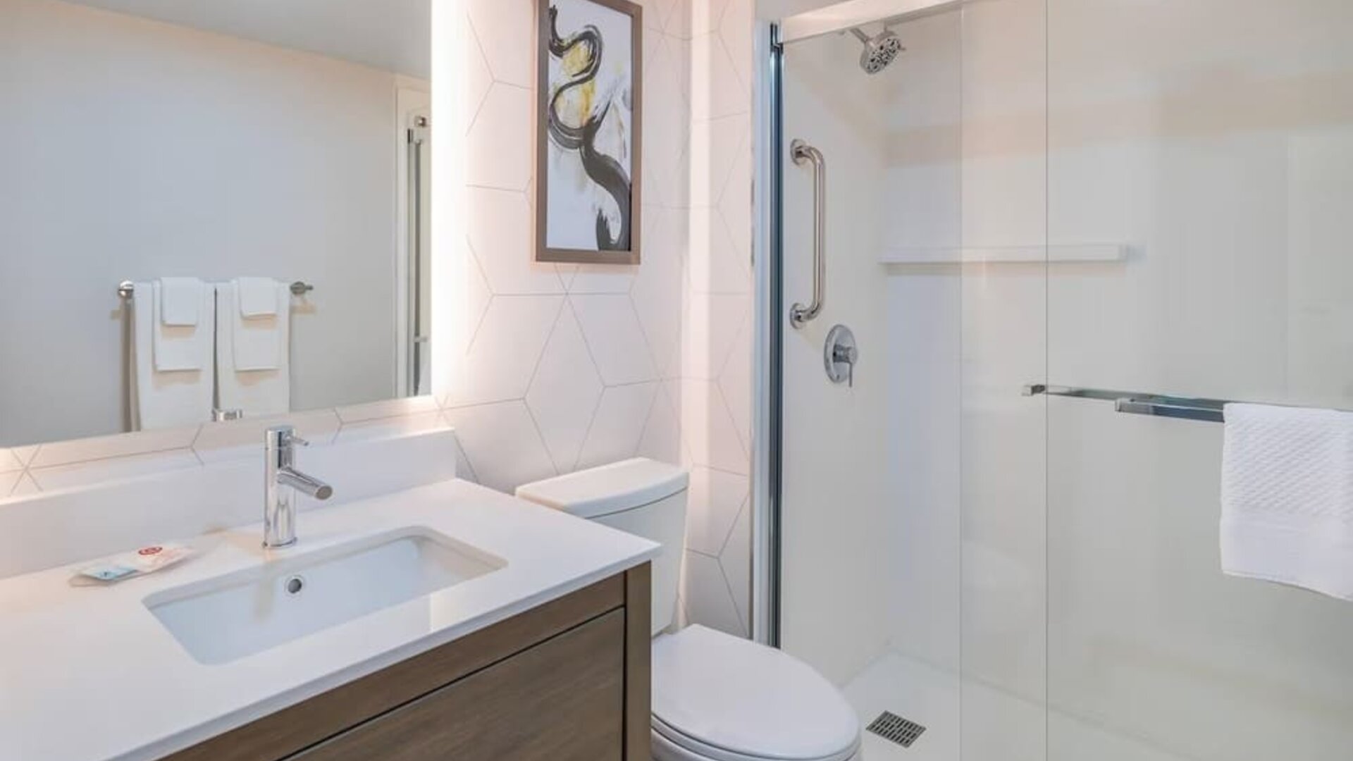 Guest bathroom with a walk-in shower and vanity at Comfort Inn Belleville.