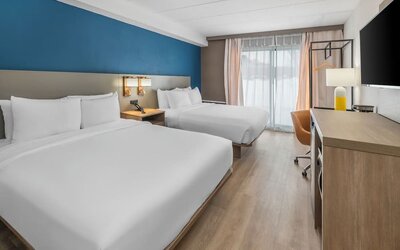Guest room with two queen beds and modern furnishings at Comfort Inn Belleville.