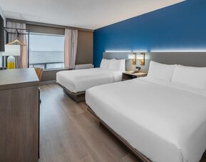Guest room with two queen beds and large window at Comfort Inn Belleville.