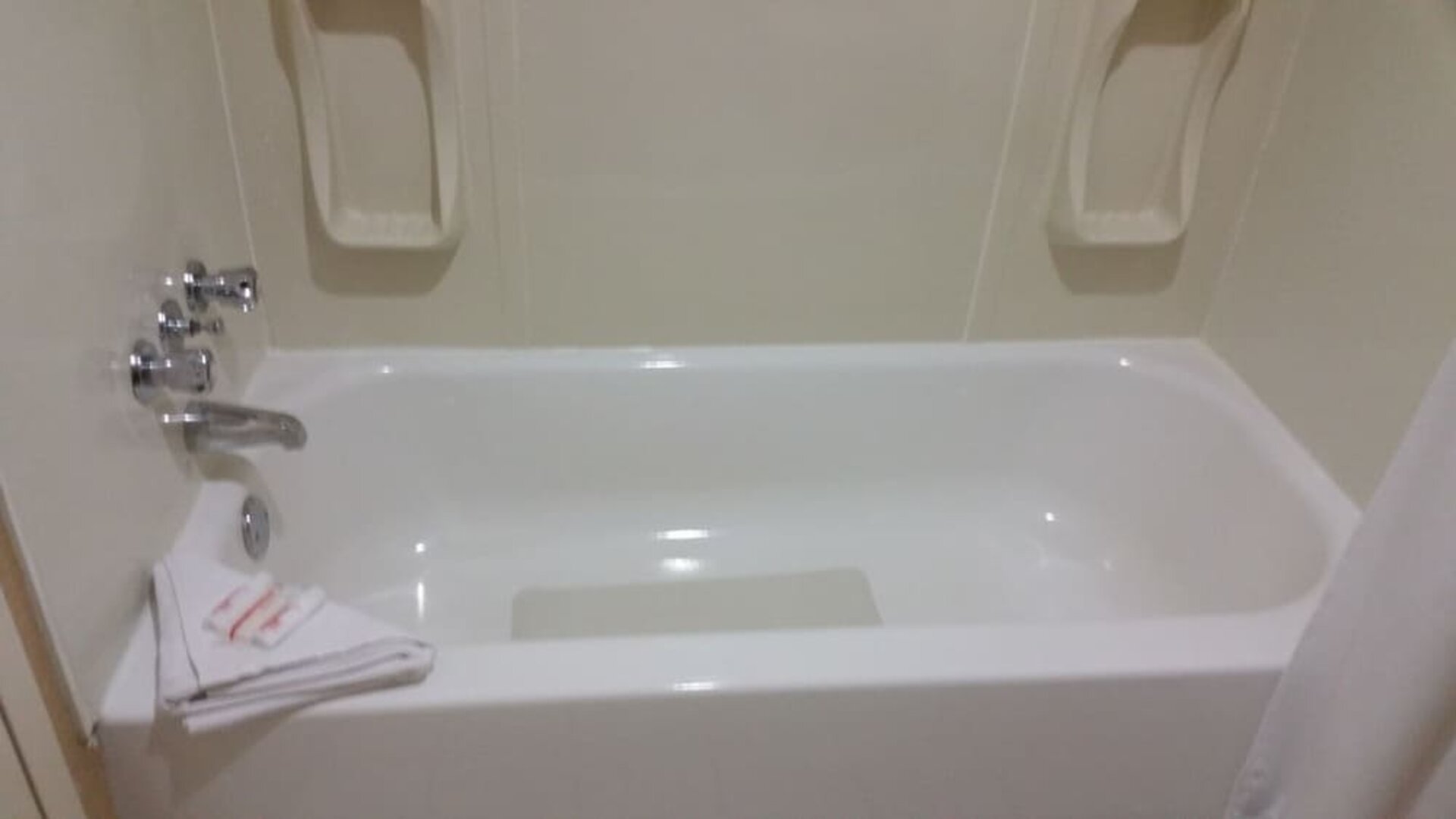 Guest bathroom with a bathtub and shower combination at Days Inn Edmonton Downtown.