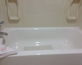 Guest bathroom with a bathtub and shower combination at Days Inn Edmonton Downtown.
