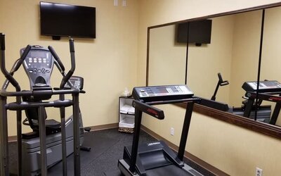 Fitness center with a treadmill and elliptical machine at Days Inn Edmonton Downtown.
