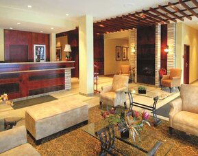 Hotel lobby with seating area and reception desk at Days Inn Edmonton Downtown.