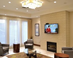 Hotel lobby with fireplace and comfortable seating at Amenida Residences.