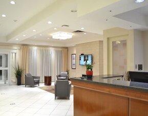 Hotel lobby with reception area and seating at Amenida Residences.