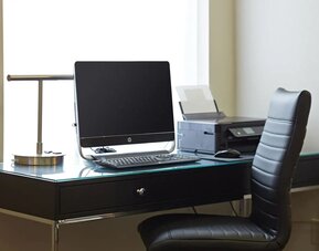 Business center with a computer and printer at Comfort Inn Winnipeg Airport.