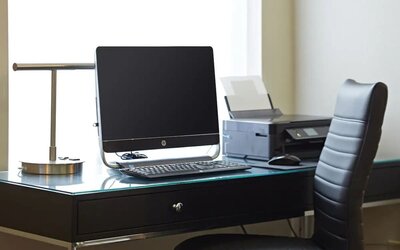 Business center with a computer and printer at Comfort Inn Winnipeg Airport.