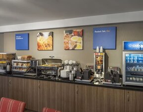 Complimentary breakfast station with hot and cold selections at Comfort Inn Winnipeg Airport.