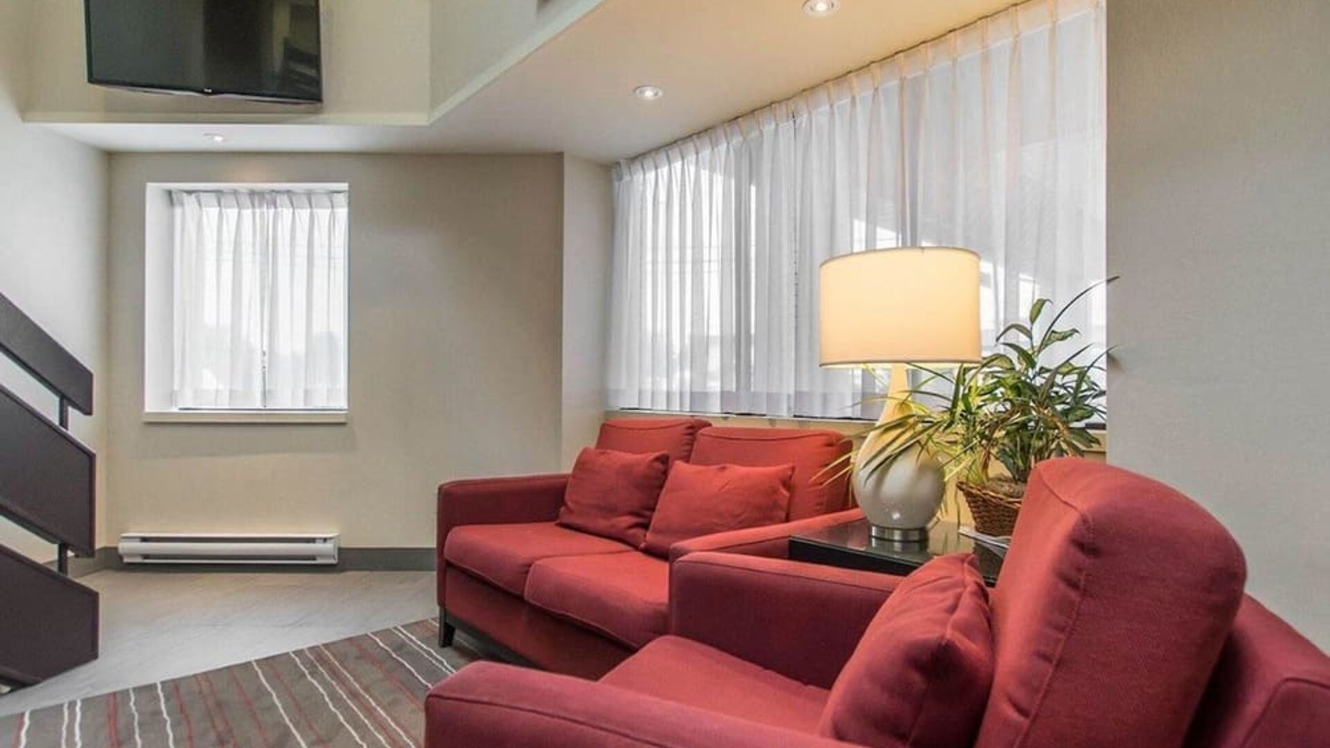 Hotel lobby with business center and reception area at Comfort Inn Val D'Or.