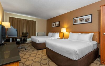 Guest room with two queen beds and a work desk at Comfort Inn Val D'Or.