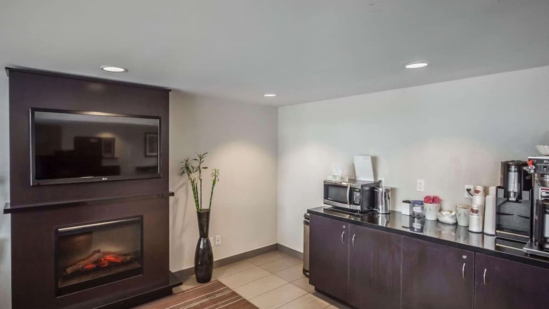 Guest lounge with a fireplace, coffee station, and seating at Comfort Inn Edmonton West.