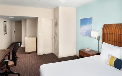 Guest room with a king bed and work desk at Sherry Frontenac Oceanfront Hotel.