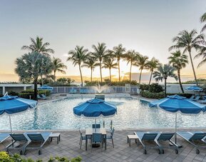 Outdoor swimming pool with lounge chairs and ocean views at Sherry Frontenac Oceanfront Hotel.