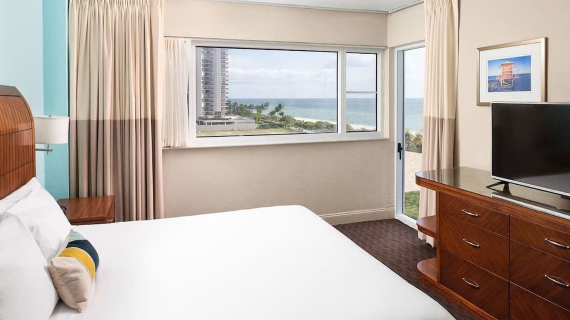 Guest room with a king bed and ocean view at Sherry Frontenac Oceanfront Hotel.