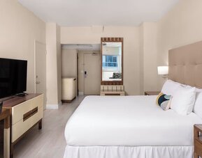 Guest room with a king bed and panoramic ocean view at Sherry Frontenac Oceanfront Hotel.
