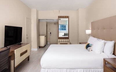 Guest room with a king bed and panoramic ocean view at Sherry Frontenac Oceanfront Hotel.